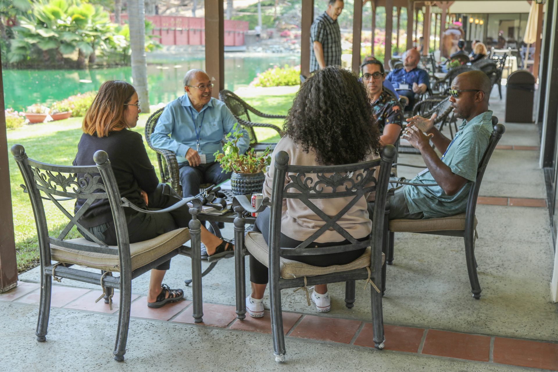 a group of people sitting around a wooden table